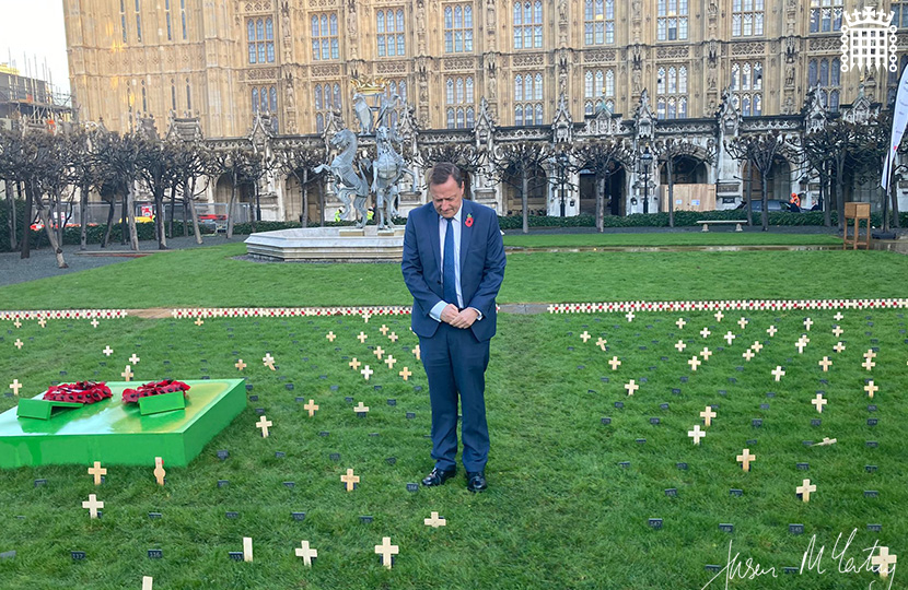 Jason McCartney MP places a Remembrance cross in the Constituency Garden of Remembrance at the Palace of Westminster